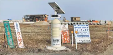  ??  ?? A Geiger counter, measuring a radiation level of 0.127 microsieve­rt per hour, is seen at an area damaged by the March 11, 2011 tsunami, near Tokyo Electric Power Co’s (TEPCO) tsunami-crippled Fukushima Daiichi nuclear power plant, in Namie town,...