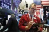  ?? AP PHOTO/RICHARD DREW ?? Trader William Lawrence works on the floor of the New York Stock Exchange.