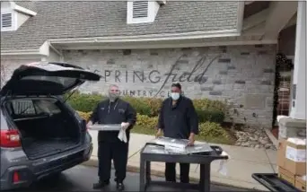  ?? SUBMITTED PHOTO ?? Springfiel­d Country Club Executive Chef Steve Balmer, left, and chef Tony Smith, right, load a vehicle to deliver meals to local homeless shelters as part of the Holiday Hunger Relief.