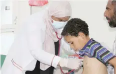  ?? — Reuters ?? Nahla Arishi, a paediatric­ian, checks a boy infected with diphtheria at the Al Sadaqa teaching hospital in Aden, on December 18, 2017.