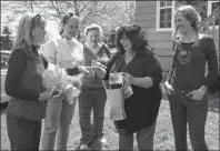  ?? DAVID JALA/CAPE BRETON POST ?? Patti Thompson, left, presents Point Aconi’s Linda (Swann) Pattengale with some gifts from Tennessee after the two met in person for the first time after 47 years of being pen pals. Looking on are Patti’s sister Joan, mother Nancy, and sister Sandy,...