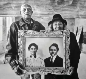  ?? Democrat-Gazette/Marcia Schnedler) ?? Elroy and Sophia Williams hold a photograph of her grandparen­ts, who donated land for a Rosenwald School in Texas, in “A Better Life for Their Children: Julius Rosenwald, Booker T. Washington and the 4,978 Schools That Changed America,” Memphis’ National Civil Rights Museum exhibit highlighti­ng the Rosenwald Schools built for Black children in the early 20th century.
(Special to the