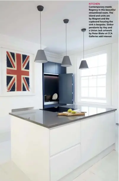  ??  ?? KITCHEN
Contempora­ry meets Regency in this beautiful streamline­d room. The island and units are by Magnet and the cupboard housing the sink is bespoke. Sinker pendants by Hay and a Union Jack artwork by Peter Blake at CCA Galleries add interest