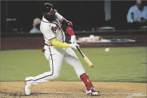  ?? ASSOCIATED PRESS ?? ATLANTA BRAVES’ MARCELL OZUNA HITS A HOME RUN against the Los Angeles Dodgers during the fourth inning in Game 4 of the National League Championsh­ip Series on Thursday in Arlington, Texas.