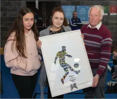  ??  ?? Sarah and Aoife, daughters of the late Pat Bracken receiving a beautiful tribute from Liam Keenan commemorat­ing Pat’s achievemen­ts as coach with the winning Aughrim Féile team of 2019.