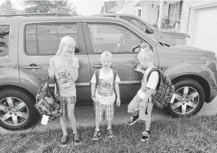  ?? Brandon Lingle / Staff ?? Helga in the background on the first day of school in 2012 — as it was in so many family milestones.