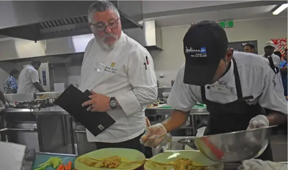  ??  ?? The beef dish competitio­n head judge, Rudolf Kunkel (left) who is Shangri-La’s Fijian Resort and Spa Executive Chef judging Radisson Blu Resort Fiji chef, Amitesh Narayan’s (right) dish. Photo: Nicolette Chambers