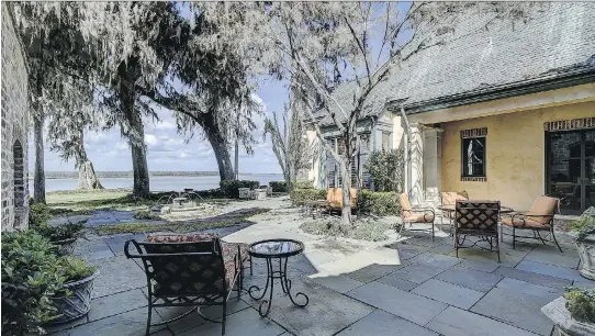  ?? PHOTOS: JASON ADAMS/LUXURY IMAGING COMPANY ?? A shaded stone patio and fountain are adjacent to the home while offering views of South Carolina’s Colleton River.