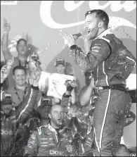  ?? AP/CHUCK BURTON ?? Austin Dillon celebrates in Victory Lane with his supporters after capturing his first victory in NASCAR’s top series, winning the Coca-Cola 600 at Charlotte Motor Speedway on Sunday.