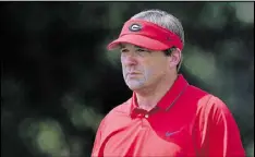  ?? BRANT SANDERLIN / BSANDERLIN@AJC.COM ?? Georgia coach Kirby Smart says he doesn’t always wear a visor and isn’t sure it’s appropriat­e for Georgia’s indoor season opener.