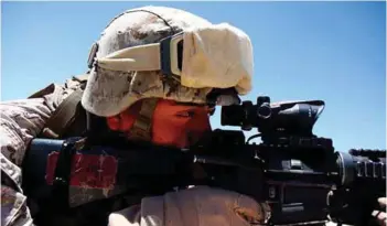  ?? PHOTOGRAPH: US DoD ?? A US Marine sights his target through an advanced combat optical gun sight scope