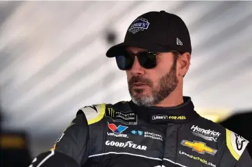  ?? Associated Press ?? ■ Jimmie Johnson climbs into his car prior to practice for today's NASCAR Cup Series auto race Saturday in Long Pond, Pa.