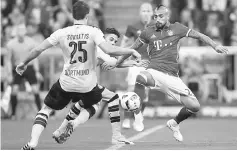  ??  ?? Bayern Munich’s ArturoVida­l in action with Borussia Dortmund’s Sokratis Papastatho­poulos during the German Bundesliga match at Allianz Arena in Munich, Germany in this April 8 file photo. — Reuters photo