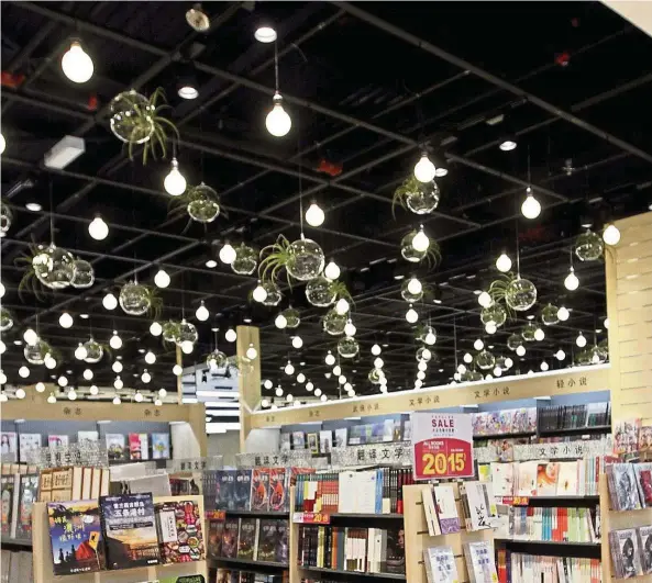  ?? — Photos: RICKY LAI/The Star ?? Rows of florescent bulbs alongside tiny plants suspended in teardrop-like cases make for a lovely surprise at the refurbishe­d bookstore.