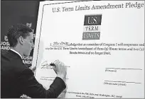  ?? [JONATHAN QUILTER/ DISPATCH] ?? State Treasurer Josh Mandel, a candidate for the U.S. Senate, signs a pledge during a news conference Monday to support term limits for Congress.