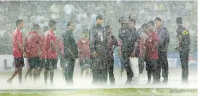  ??  ?? Monsoon mayhem: groundstaf­f at the 2002 Champions Trophy final