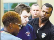  ?? GERALD HERBERT — THE ASSOCIATED PRESS ?? Kenneth James Gleason is escorted by police to a waiting police car in Baton Rouge, Louisiana, on Tuesday. Gleason is charged with two counts of first-degree murder and other charges for three shootings throughout the past week that resulted in the...