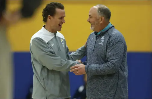  ?? NHAT V. MEYER — STAFF ARCHIVES ?? Serra interim head coach Brian Carson, left, talks with Bellarmine head coach Patrick Schneider before a game in 2020. Schneider has decided to retire from coaching but will continue teaching religious studies courses.