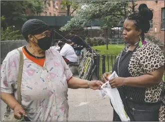  ??  ?? Muschett-Owes (right) talks to a resident at Lafayette Gardens housing developmen­t.