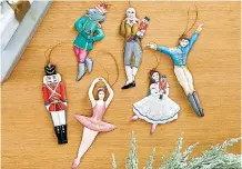  ?? Associated Press ?? ■ Ballard Designs' Nutcracker collection of ornaments. Each handmade, handpainte­d 3D ornament features a character from the iconic holiday ballet.