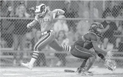  ?? MICHAELLAU­GHLIN/SOUTH FLORIDASUN SENTINEL ?? Park Vista’s Christina Penney scores in front of Cooper City catcher Kirsten Caravaca on Friday.