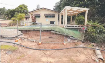  ??  ?? The front of the badly damaged Poinciana Motel on Tweed Valley Way has been fenced off until repairs can be done.