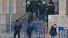  ?? (AP/Mehmet Guzel) ?? Police officers provide security outside an Istanbul courthouse where Can Dundar, the former editor-in-chief of opposition newspaper Cumhuriyet, was convicted Wednesday.