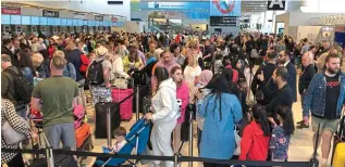  ?? ?? Long delays: Queues at check-in at Manchester airport this week