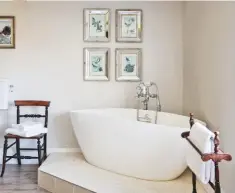  ??  ?? BATHROOM The bath was built on a raised plinth, cleverly concealing the plumbing while creating a focal point. The Metropolit­an freestandi­ng bath, from £890, Bathstore, would suit this space. Victorian beech freestandi­ng towel rack, £42, Vintage Farmhouse, has the same look