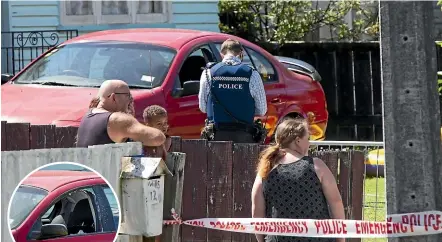  ?? ROSS GIBLIN/STUFF ?? Police inspect the property in Hanson Grove, Stokes Valley where a man was shot on Saturday night. The car’s window was shattered.