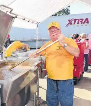  ??  ?? Terry Bavousette, a member of Oklahoma Baptist Disaster Relief, stirs a pot of beef stew in a 40-gallon tilt skillet as part of disaster relief efforts in Baton Rouge, La.