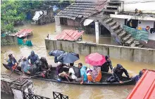  ?? PHOTO: PTI ?? Rescue personnel assist villagers out of a flooded area following heavy monsoon rainfall, near Kochi on Wednesday