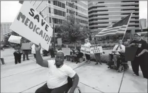  ?? The Associated Press ?? INSURANCE MARKETPLAC­ES: Mario Henderson leads chants of “save Medicaid” as other social service activists, Medicaid recipients and their supporters stage a protest Thursday outside the building that houses the offices of U.S. Sen. Thad Cochran,...