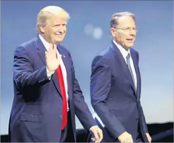  ?? Scott Olson Getty Images ?? DONALD TRUMP campaigns with National Rifle Assn. leader Wayne LaPierre last year. LaPierre has said “the three most dangerous voices” in America are academic elites, political elites and media elites.