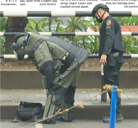  ?? PHOTOGRAPH BY BOB DUNGO JR. FOR THE DAILY TRIBUNE @tribunephl_bob ?? Better safe… The motorcycle storage box abandoned at Plaza Ferguson across the United States Embassy in Manila is checked by members of the Manila Police District bomb disposal unit. A controlled detonation opened the empty box.