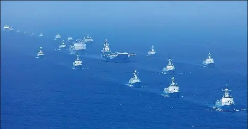  ?? PHOTOS BY LI GANG AND MO XIAOLIANG / XINHUA ?? President Xi Jinping, also general secretary of the Communist Party of China Central Committee and chairman of the Central Military Commission, reviews the PLA Navy’s parade on Thursday in the South China Sea. Right: The naval parade was the nation’s...