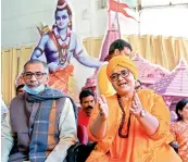  ?? - PTI ?? BJP MP Sadhvi Pragya Singh Thakur with office-bearers of Vishwa Hindu Parishad addresses a gathering after donating a cheque of `1,11,111 lakh for the proposed constructi­on of Ram Temple at Ayodhya under a nationwide donation drive in Bhopal on Friday.