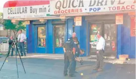  ?? JAKE WITTICH/SUN-TIMES ?? Police investigat­e where four men were shot in front of a West Garfield Park store on Wednesday.
