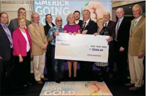  ??  ?? Members of the Abbeyfeale Town Park committee with their prize for €7,000 in the Limerick Going for Gold competitio­n awarded last week and at which Abbeyfeale came in second place to the tourist jewel of Adare.