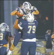  ?? SPECIAL NWA DEMOCRAT-GAZZETTE/DAVID BEACH ?? Bentonvill­e West Jaden Muskrat (79) celebrates with a teammate during a game at Wolverine Stadium in Centerton on Sept. 27.