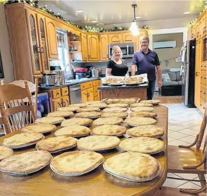  ?? Kelly Pitre/Special to The Guardian ?? Kelly Pitre, left, and her older brother, Rick Gavin, carry out the Christmas in July tradition by making meat pies. This year the pair made 30 of them.