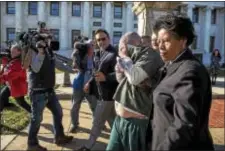  ?? RICK KAUFFMAN – DIGITAL FIRST MEDIA ?? Michael Cripps, 43, is hounded by reporters on his charges of molesting children in Delaware County, hiding his face as he is led by Det. Paul Corsi, left, and Sgt. Robin Clark, right, both of the Delaware County CID Child Abuse Unit.