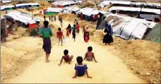  ?? Picture: REUTERS ?? DOWNHILL STRUGGLE: Rohingya refugee children slide down the road at Balu Khali refugee camp in Bangladesh, yesterday.