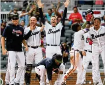  ?? SCOTT CUNNINGHAM / GETTY IMAGES ?? Charlie Culberson’s walk-off, two-run, pinch-hit home run in the first game of the Braves’ rain-soaked double-header Monday had teammates Sean Newcomb, Tyler Flowers, Freddie Freeman, Ozzie Albies and Johan Camargo in ecstasy.