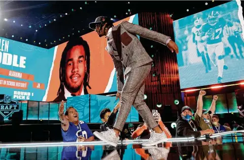  ?? Gregory Shamus / Getty Images ?? Former Episcopal and Alabama star receiver Jaylen Waddle strolls onstage after the Dolphins drafted him sixth overall. Story on Page C2.