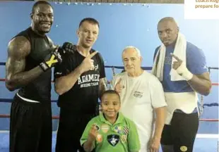  ??  ?? KLITSCHKO AWAITS: Scott [right] and Wilder help Tomasz Adamek and coach Roger Bloodworth prepare for Vitali in 2011