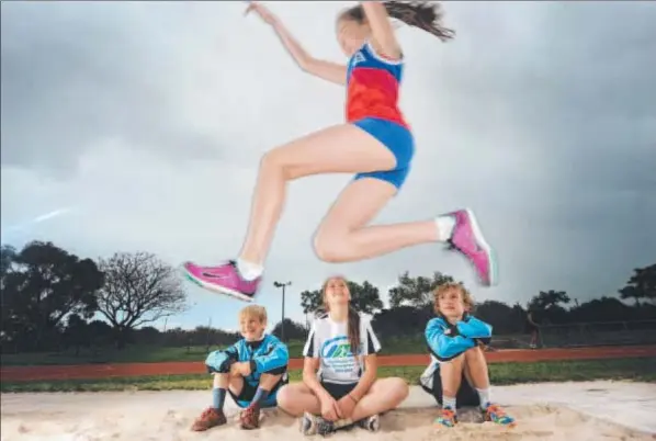  ?? Photo: MITCH BEAR ?? SET TO FLY: Caitlin Kennedy takes flight for a long jump while Austin Anthony, Briely Wight and Will Anthony watch on.