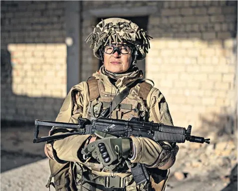  ?? ?? On Saturdays, Mariana Zhaglo, who works in market research, doubles as a unit commander in Ukraine’s territoria­l defence force