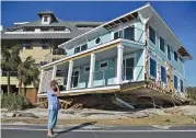  ?? (AFP) ?? A woman reacts after seeing the damage caused by Hurricane Michael in Mexico Beach, Florida on Friday