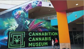  ?? PHOTPOS JOHN LOCHER/THE ASSOCIATED PRESS ?? People walk by the Cannabitio­n cannabis museum in Las Vegas, which pays tribute to all aspects of cannabis and its consumptio­n and role in the culture.